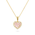 Gold heart-shaped pendant with pink gemstones on a white background
